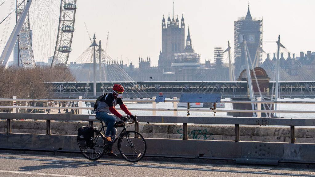 cycling across a bridge in London