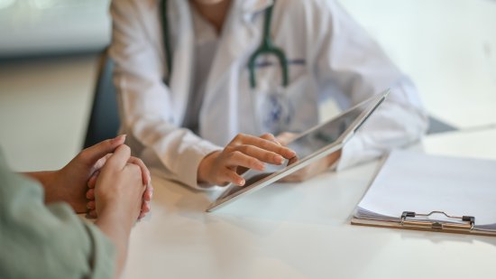 Shot of a doctor showing a patient some information