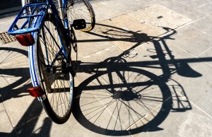 Bicycle Casting A Shadow On The Pavement