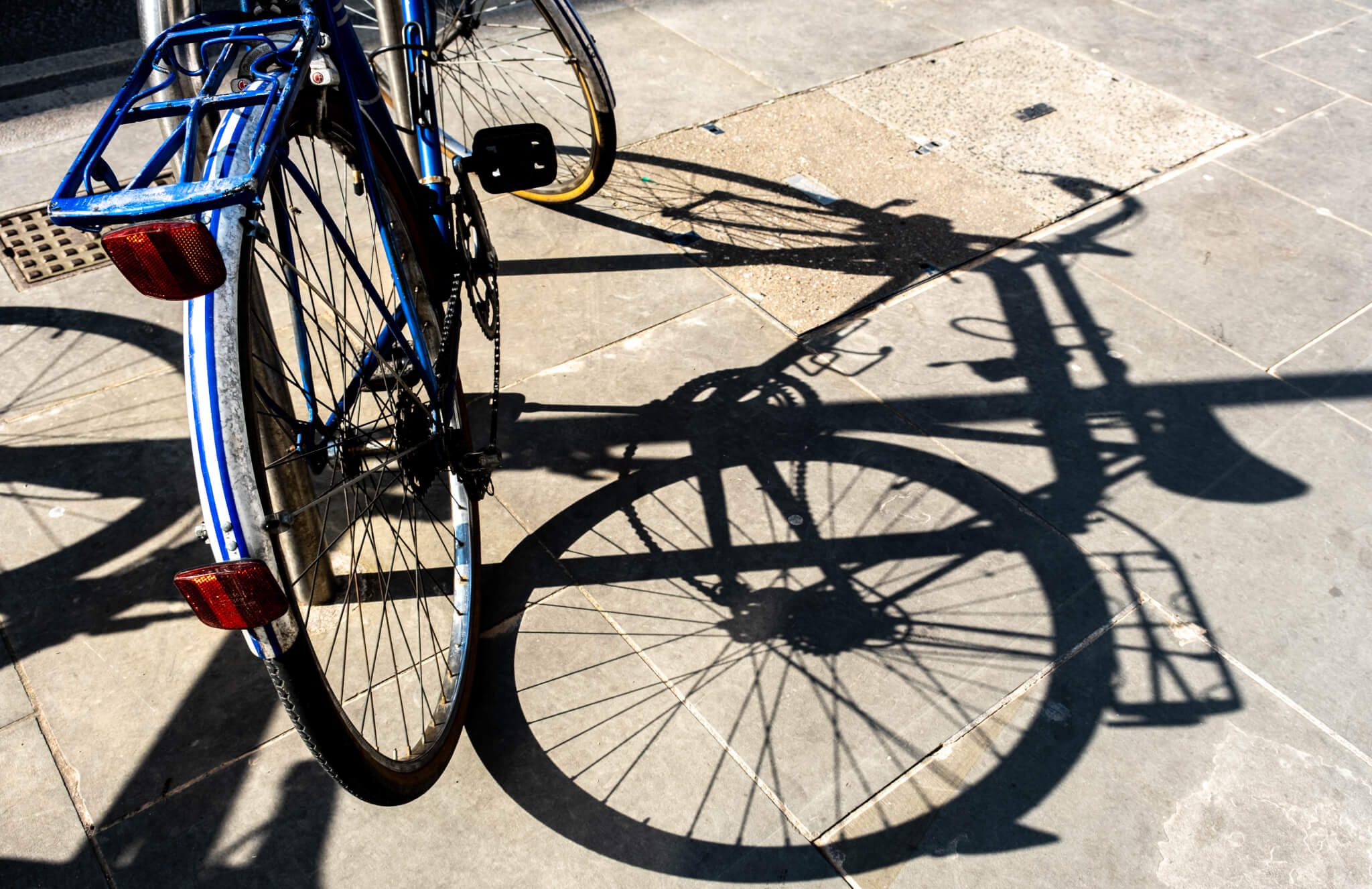 Bicycle Casting A Shadow On The Pavement