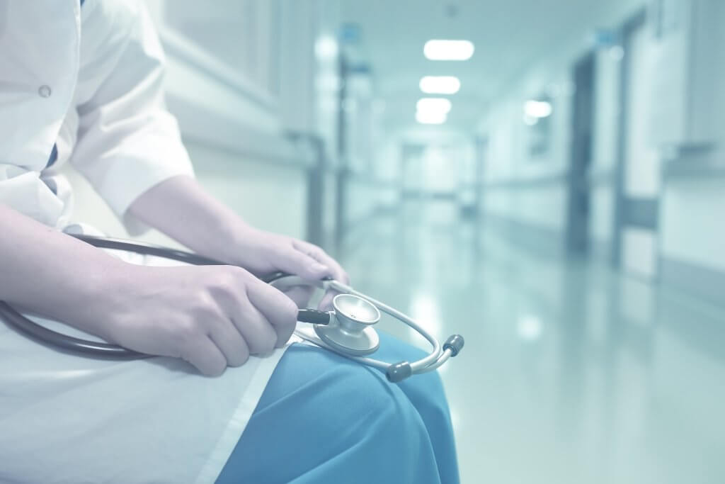 Medical doctor in empty hospital corridor