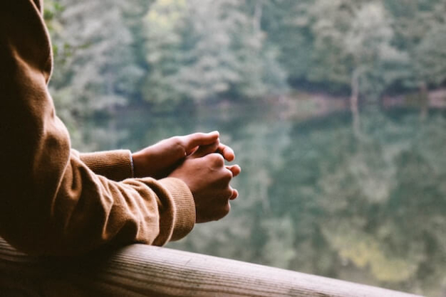 man looking at a lake