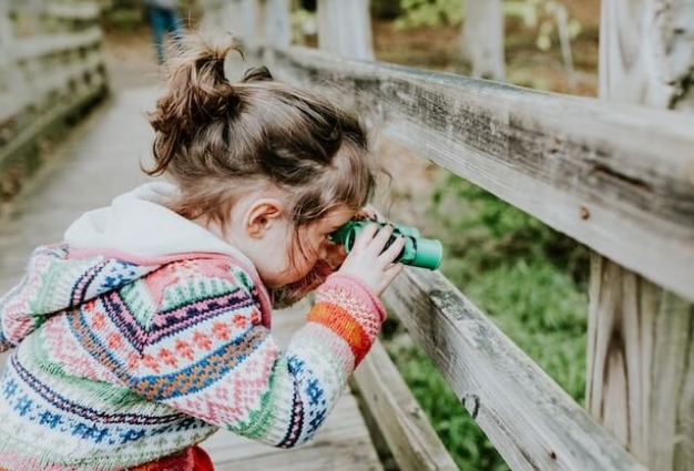 girl looking through binoculars