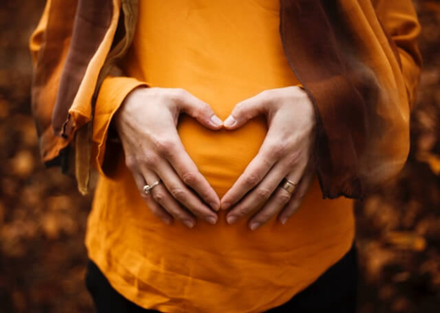 pregnant lady making a heart shape